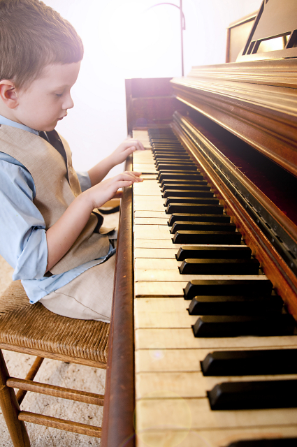 Young boy playing playing piano