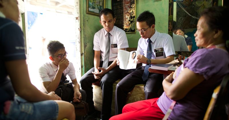 Missionaries teaching a family